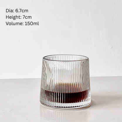 Lifestyle shot of Simple Palette Ribbed drinking glass with iced coffee and greenery